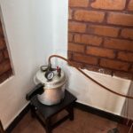 Pressure cooker generating steam for Ayurvedic steam box during Panchakarma retreat in Kerala